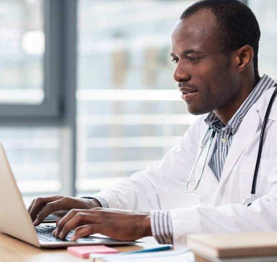 Man doctor using laptop